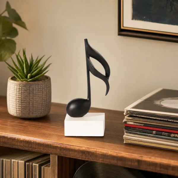 Matte Black Musical Note Sculpture on Cream Block
